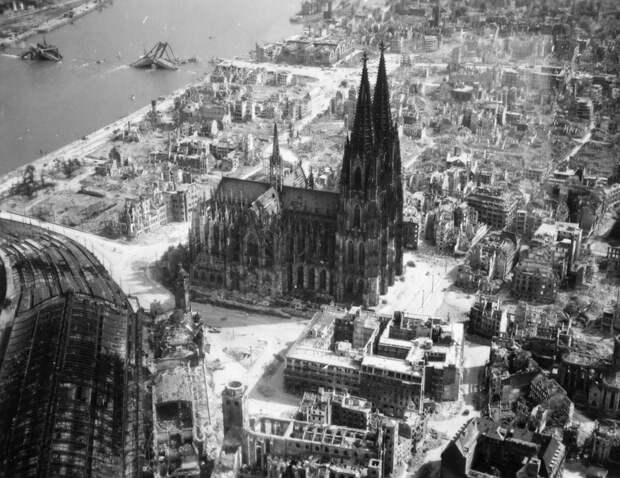 The Cologne Cathedral stands tall amidst the ruins of the city after allied bombings, 1944