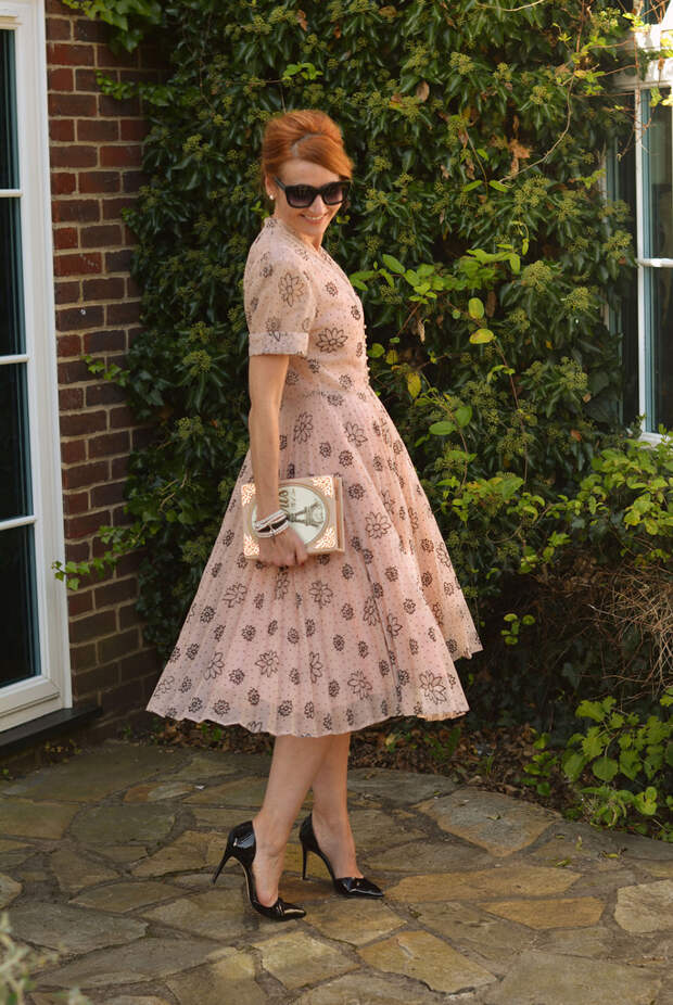 Wedding guest outfit: Vintage 1950s patterned dress, novelty clutch, hair chignon