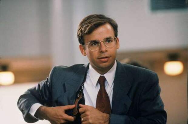 Rick Moranis as Barney Coopersmith, reaching for gun in holster