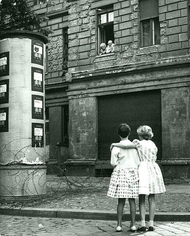 Две девочки разговаривают со своими бабушкой и дедушкой над колючей проволокой, которая позже стала Берлинской стеной. 1961 20 век, история, фотографии