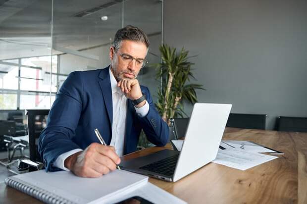 A person at a desk taking notes.