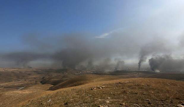 Smoke rises from the site of U.S.-led air strikes in the town of Sinjar