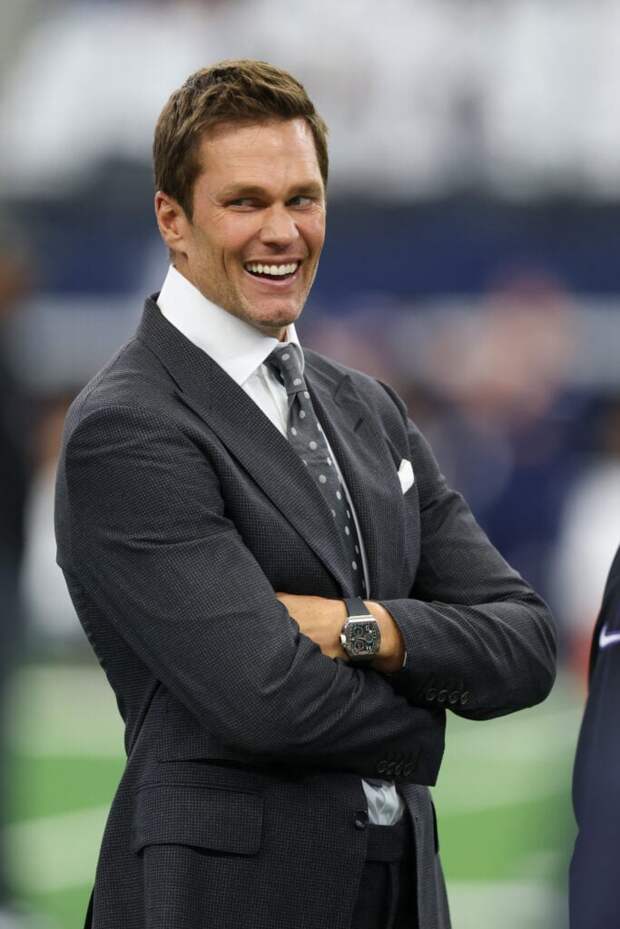 Former NFL player Tom Brady laughs before a game between the Dallas Cowboys and the Baltimore Ravens at AT&T Stadium on September 22, 2024 in Arlington, Texas. 