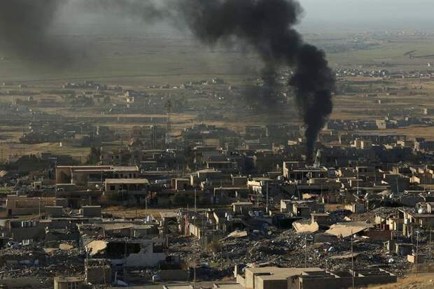 Smoke rises from the site of U.S.-led air strikes in the town of Sinjar