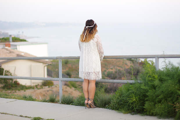 gazing out to the sea in a lace dress