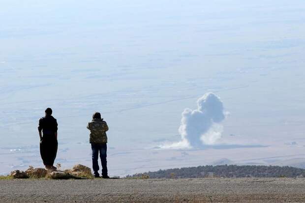 Smoke rises from the site of U.S.-led air strikes in the town of Sinjar
