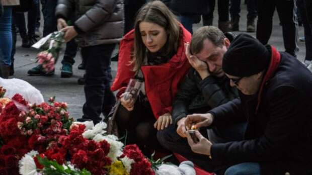 Люди у мемориала из цветов в Пулково