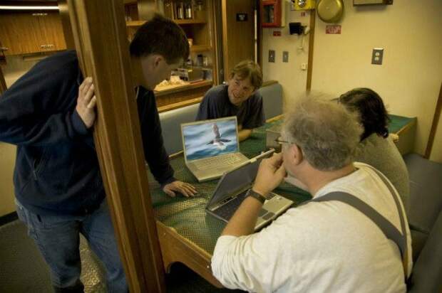 men-talking-at-table-610x406