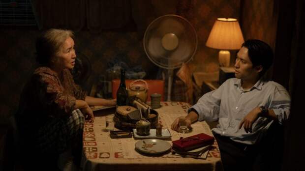Halmoni and Solomon sit at her table