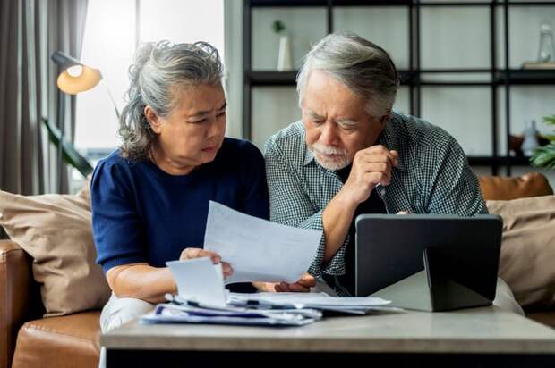 Couple discussing document together.