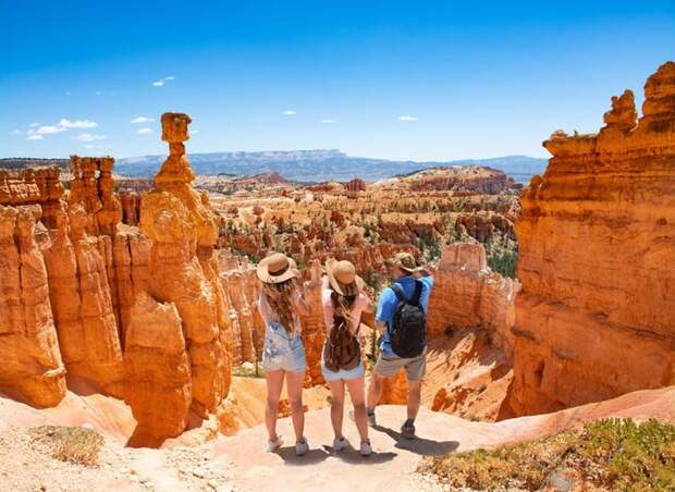 A family taking in the desert view of red rock formations.