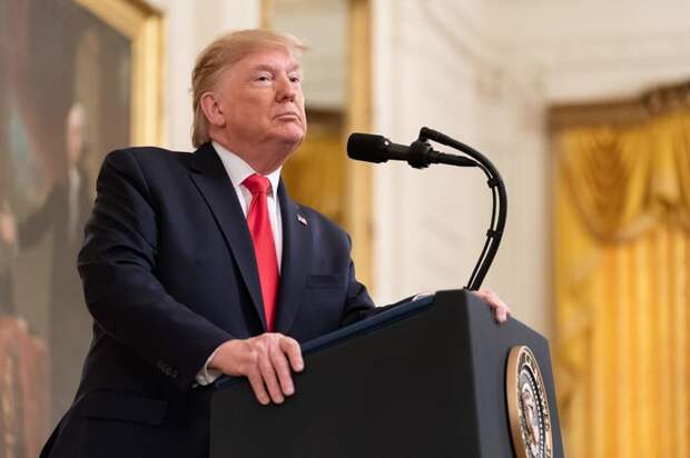 Donald Trump speaking with reporters in the East Room of the White House.