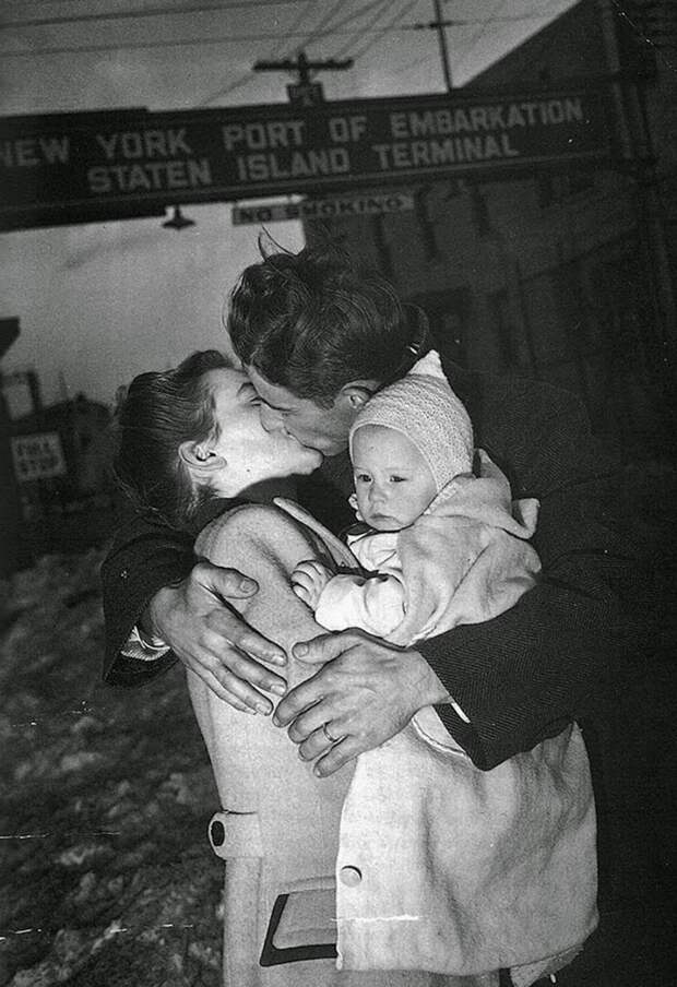 A soldier is welcomed home by his wife and baby, 1940s