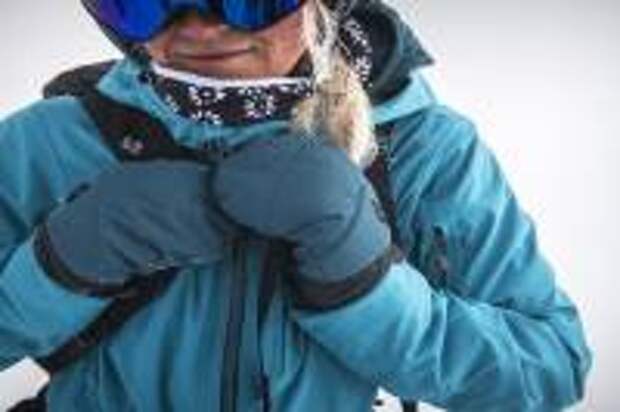 Person Wearing Black Diamond blue softshell jacket and blue insulated mittens and goggles