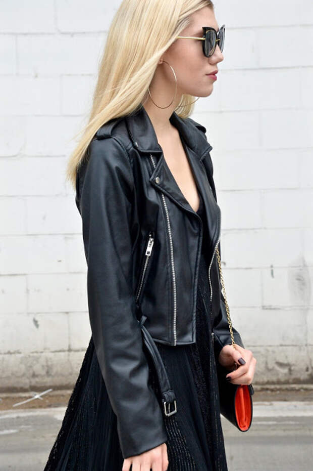 Profile view of cat-eye glasses in a all black fall outfit