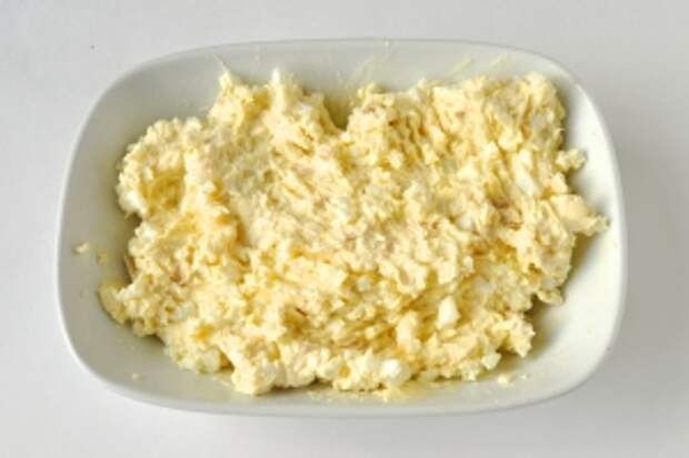 Размягчённое масло раздавить вилкой и смешать с сыром и яйцами, посолить.