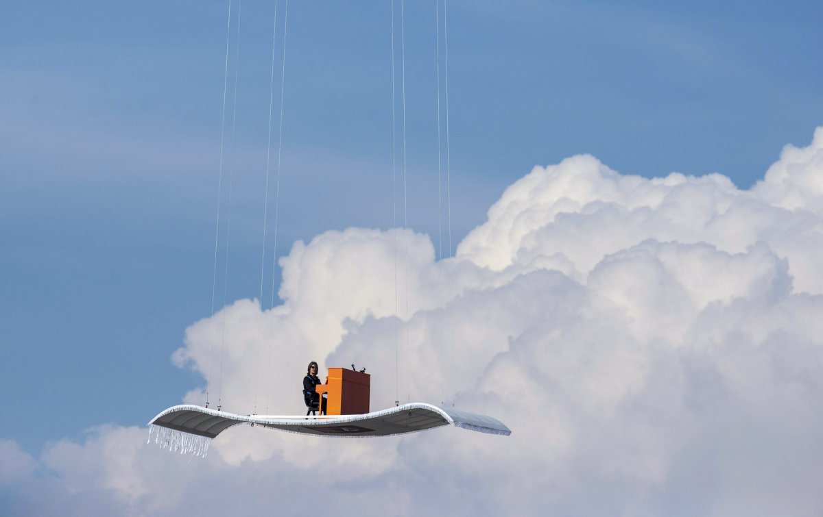 german-pianist-stefan-aaron-plays-an-orange-piano-on-a-flying-carpet-platform-suspended-from-a-helicopter-over-the-munich-airport-in-germany-on-july-23-the-concert-is-the-fourth-station-of-the-orange-piano-tour-which-bri