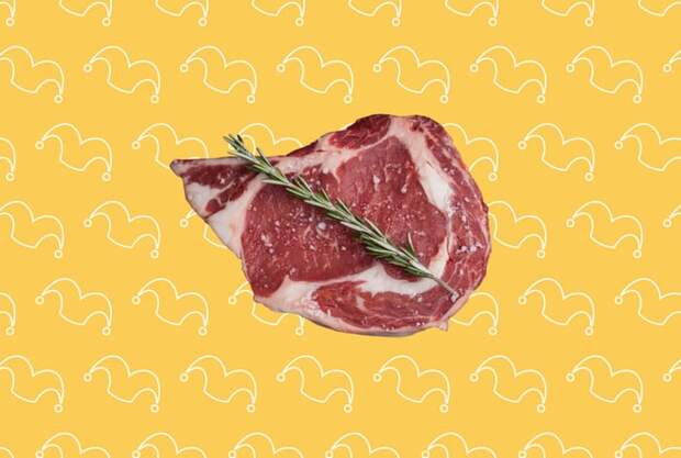 A ribeye steak on top of a yellow background