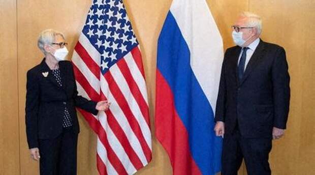 U.S. Deputy Secretary of State Wendy Sherman (L) and Russian Deputy Foreign Minister Sergei Ryabkov pose in front of their national flags before a meeting at the U.S. diplomatic mission in Geneva, Switzerland July 28, 2021. U.S. Mission Geneva/Handout via REUTERS ATTENTION EDITORS - THIS IMAGE HAS BEEN SUPPLIED BY A THIRD PARTY. MANDATORY CREDIT.