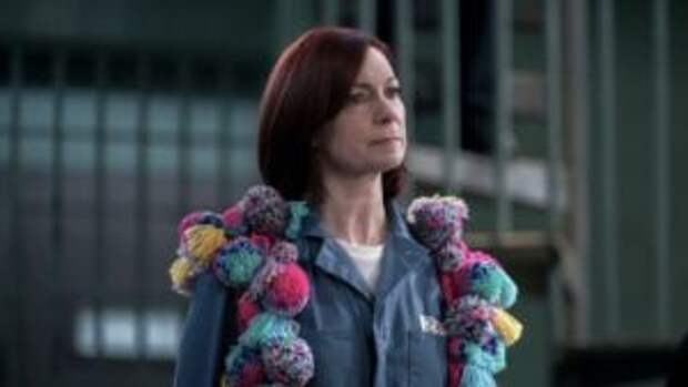 Elsbeth wearing yarn pom-poms over her jail uniform on Elsbeth Season 2 Episode 20