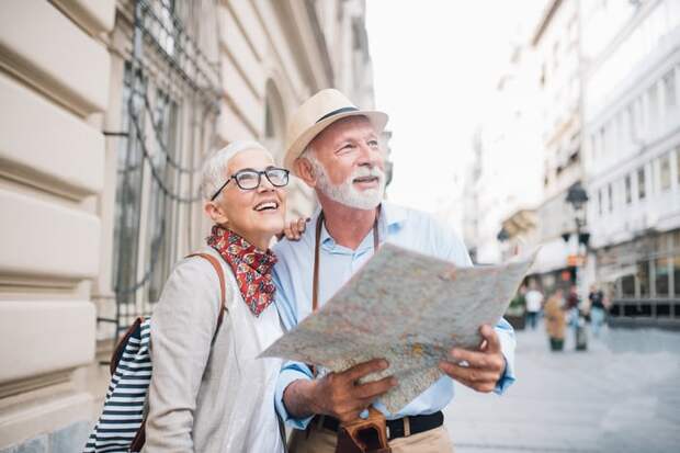 Two people holding a map and looking up.