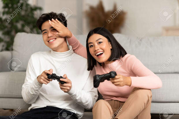 155871726-happy-asian-couple-playing-computer-video-game-sitting-on-couch-at-home-japanese-boy...jpg