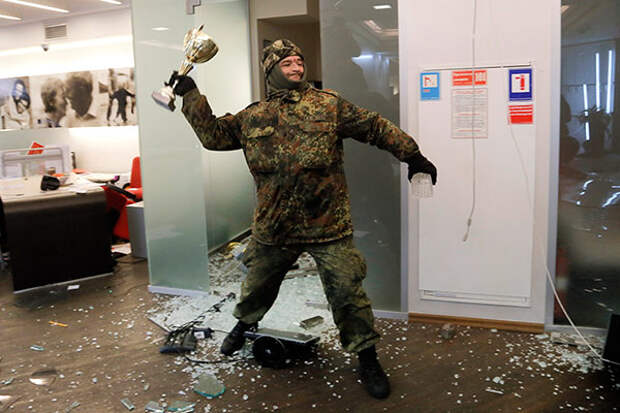 An ultra-right activist attacks an Alfa bank office in central Kiev, Ukraine, Saturday, Feb. 20, 2016.