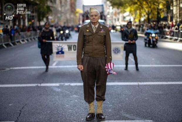 World War II Army veteran poses for a photograph as he marches in the New York City Veterans Day parade on 5th Avenue in New York