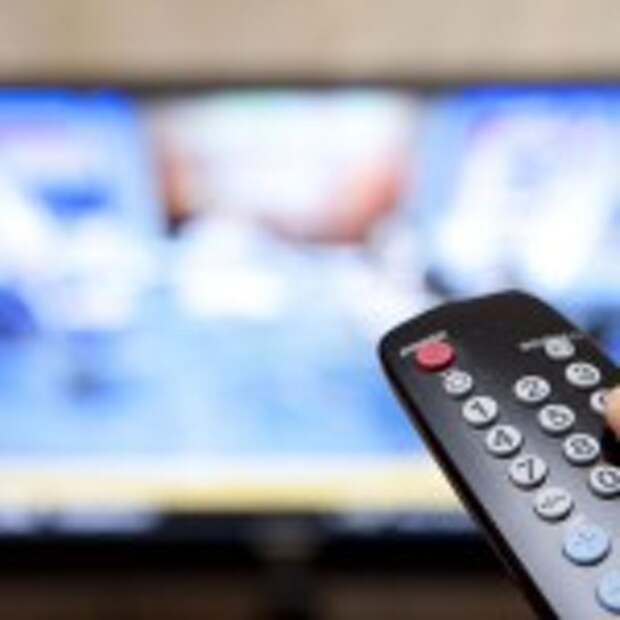 Television remote control changes channels thumb on the blue TV screen