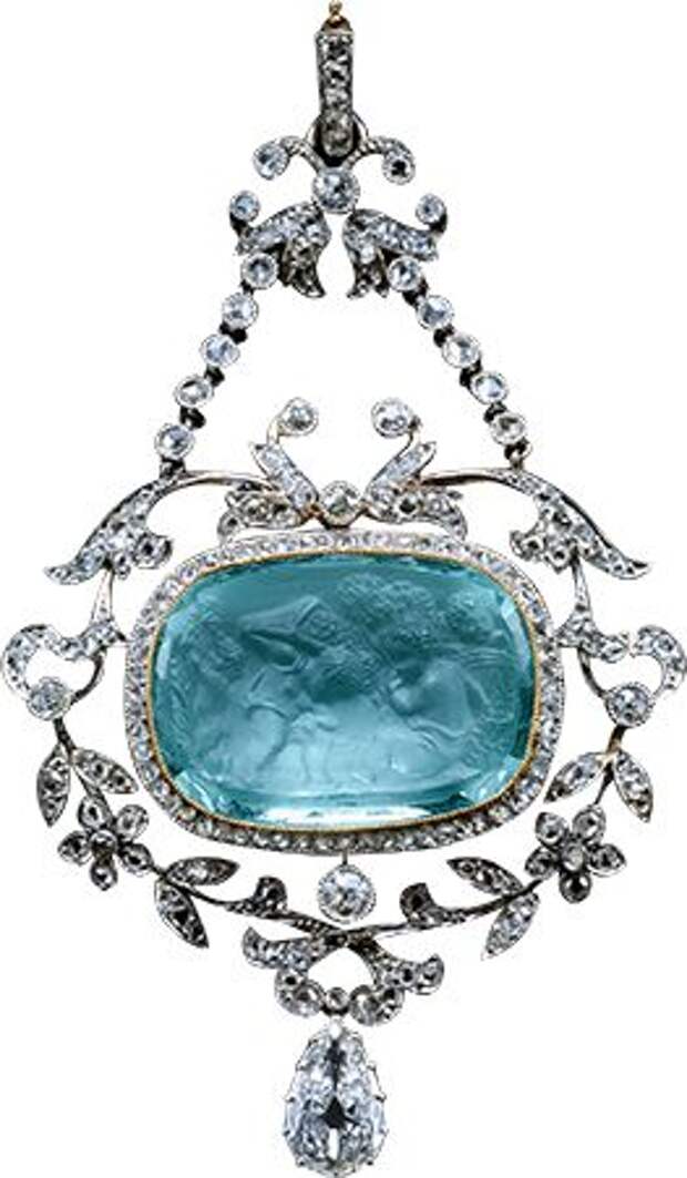 A Belle Epoque pin of an aquamarine cameo with facetted back- 4 Cupids (putti) playing the part of vintagers. Mounted as a pendant within a rose diamond mille-grain border, hanging within an open frame of floral & leafy branches with a pear shaped diamond hanging below, it is attached by chains to the trumpet shaped flower heads & the suspension loop at the top, all diamond set. Cameo: 18th century style. Pendant: 1905.