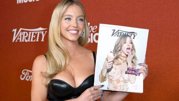 sydney sweeney holding up her magazine cover
