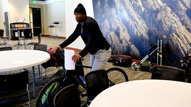 Deion Sanders works out on the stationary bike.