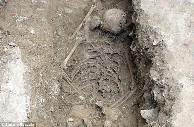 A young girl, rejected by an ancient community, was said to have been buried (remains pictured) face down to prevent her spirit from rising from the grave at just 13 years old. Experts believe she was considered dangerous in the Middle Ages, perhaps because of her pale complexion or blood disorder