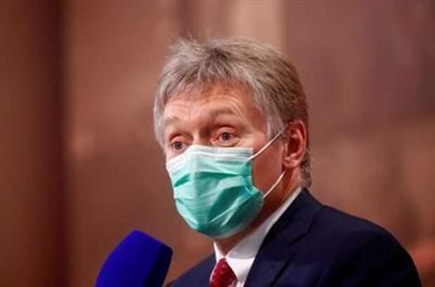 FILE PHOTO: Kremlin spokesman Dmitry Peskov wearing a protective face mask attends Russian President Vladimir Putin's annual end-of-year news conference, held online in a video conference mode, in Moscow, Russia December 17, 2020. REUTERS/Maxim Shemetov/File Photo